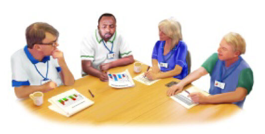 Multi-disciplinary team sat around table in meeting