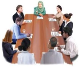 Multi-disciplinary team sat around a table during a meeting