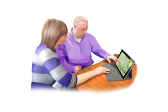 Two people looking at and using a laptop